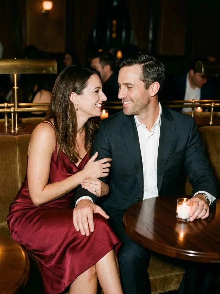 A relaxed, smiling couple at a candlelit table