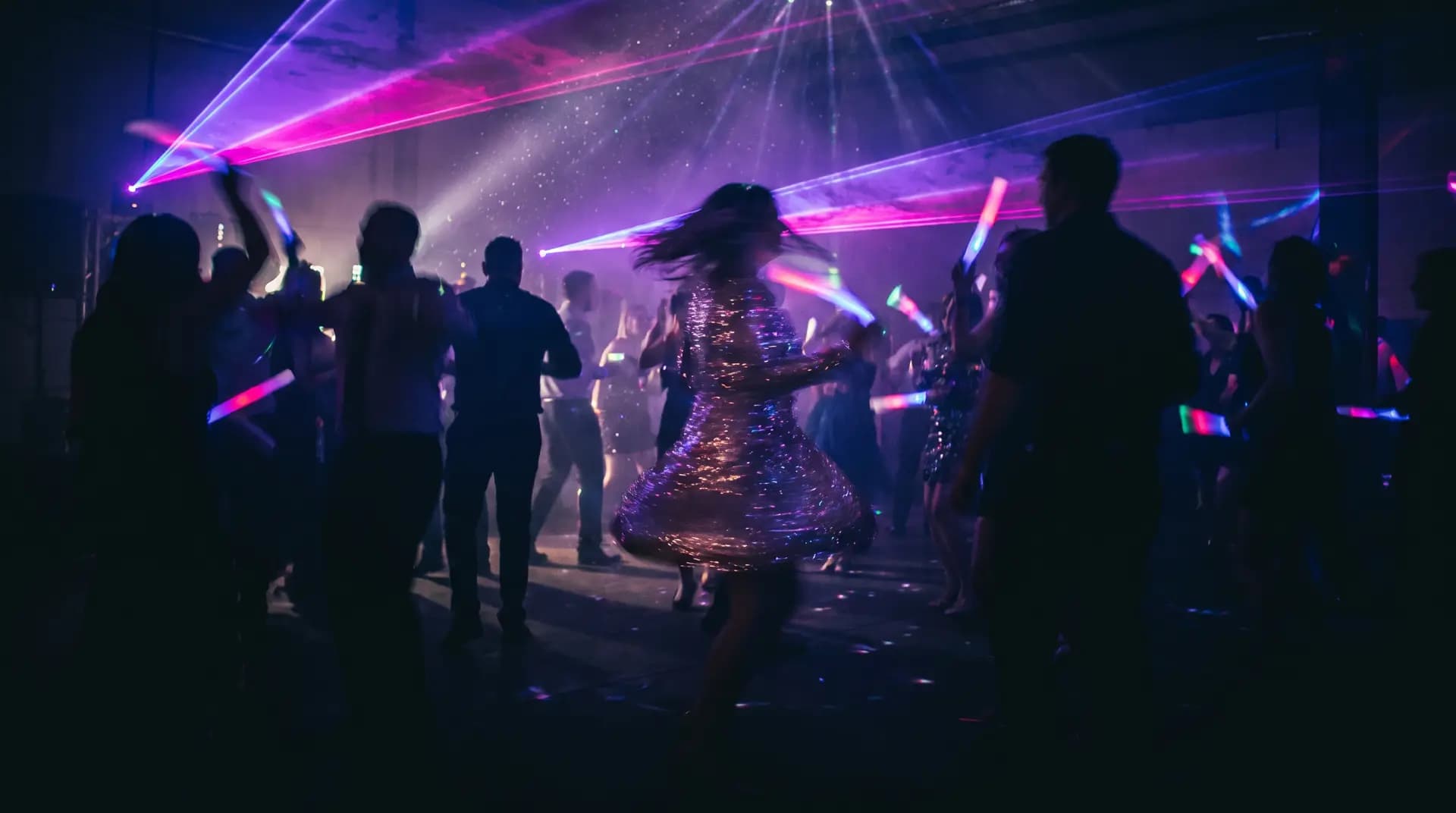 Silhouetted dancers under warm lights at a private evening gathering