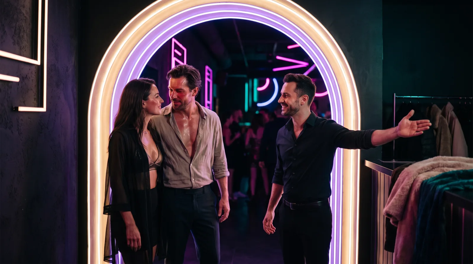 A couple is warmly greeted by a host at a lifestyle club's glowing entrance